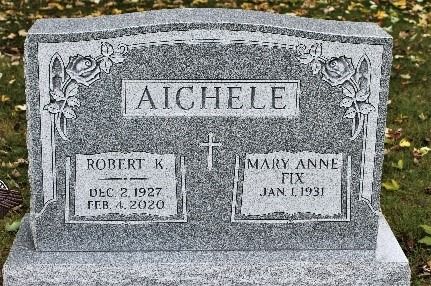 Gray granite Aichele gravestone with carved floral corners and two name plaques.