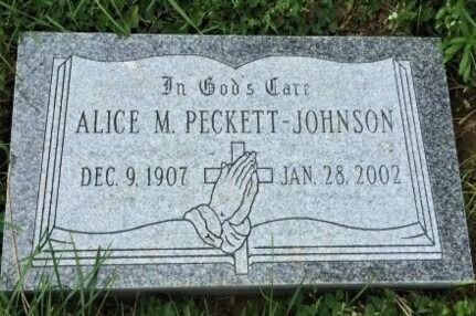 Gray gravestone in grass engraved “In God’s Care” with a rose and the name Alice M. Peckett-Johnson