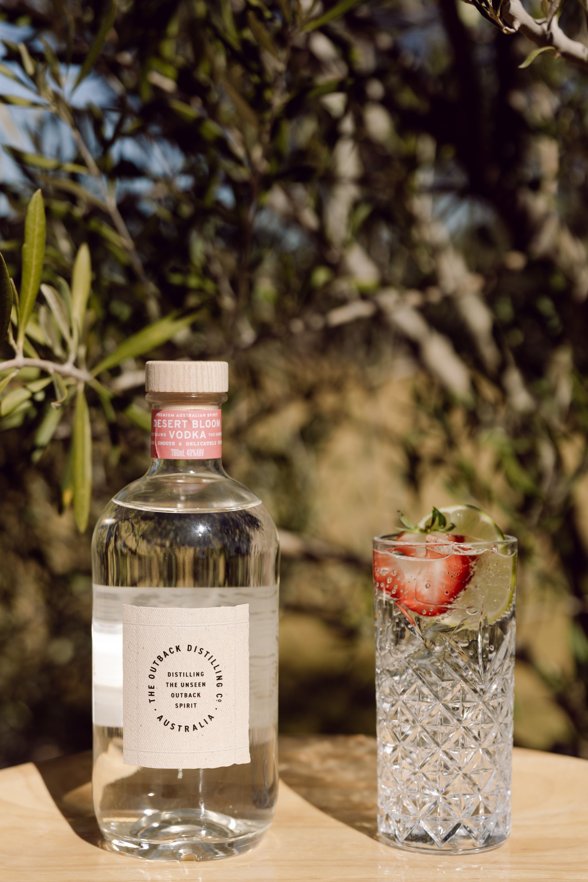 Australian Native Dry Gin by The Outback Distilling Co on barrel in distillery setting.