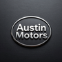 Austin Motors logo in white text inside a chrome oval on a dark textured background