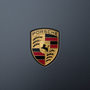 Porsche crest badge on a dark gray background