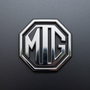 Chrome MG octagonal car emblem on a gray background