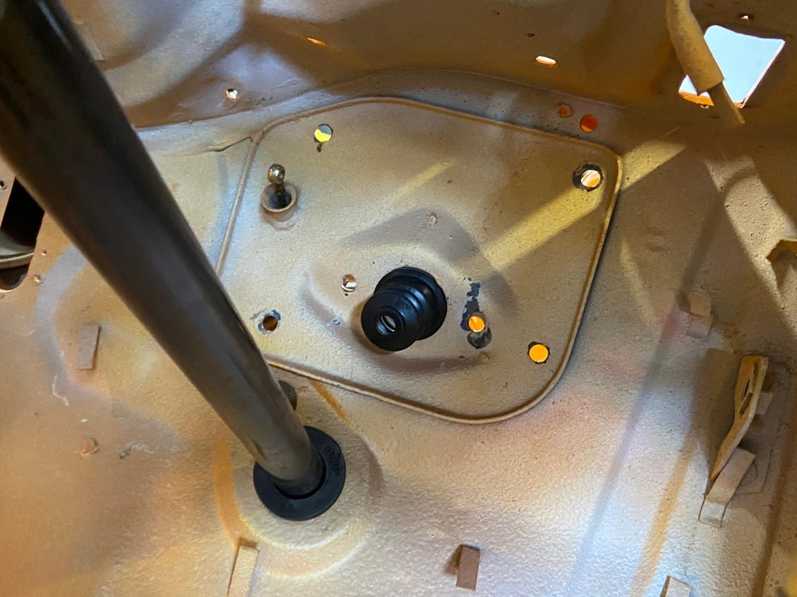 Inside a car, close-up of a gear shift and console with black knobs and yellow indicator lights.