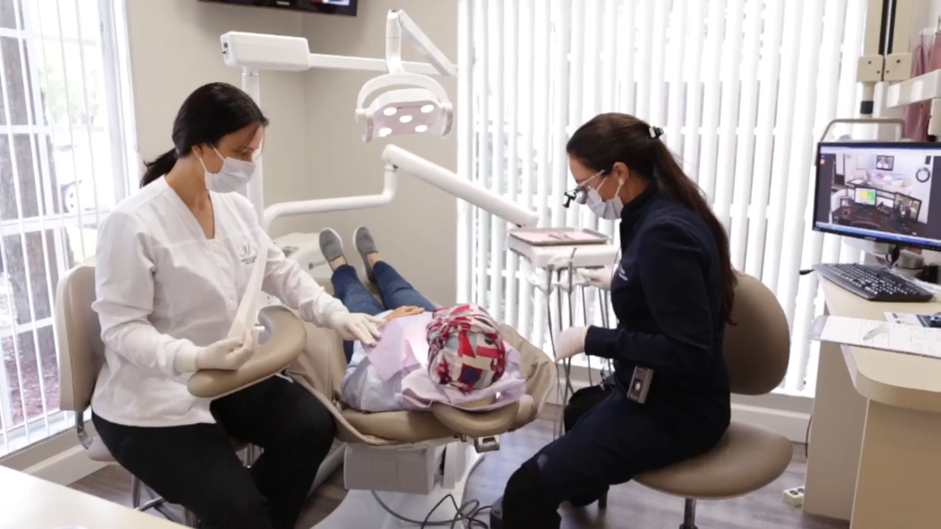 Close-up of a woman getting her teeth examined by a gloved dentist