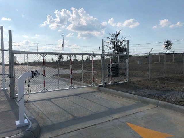 A gate with a yellow arrow pointing to the right