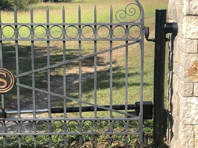 A wrought iron gate with the letter s on it