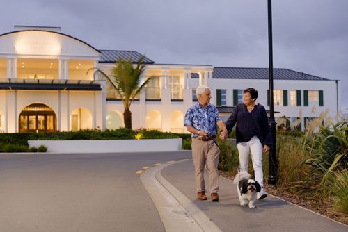 Couple walking with dog at Burlington village