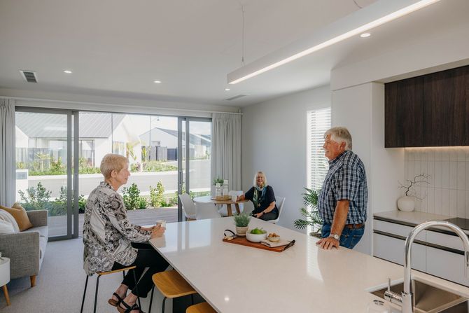 Residents chatting in Qestral kitchen