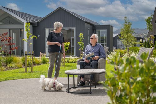 Residents relaxing outdoors with pet dog