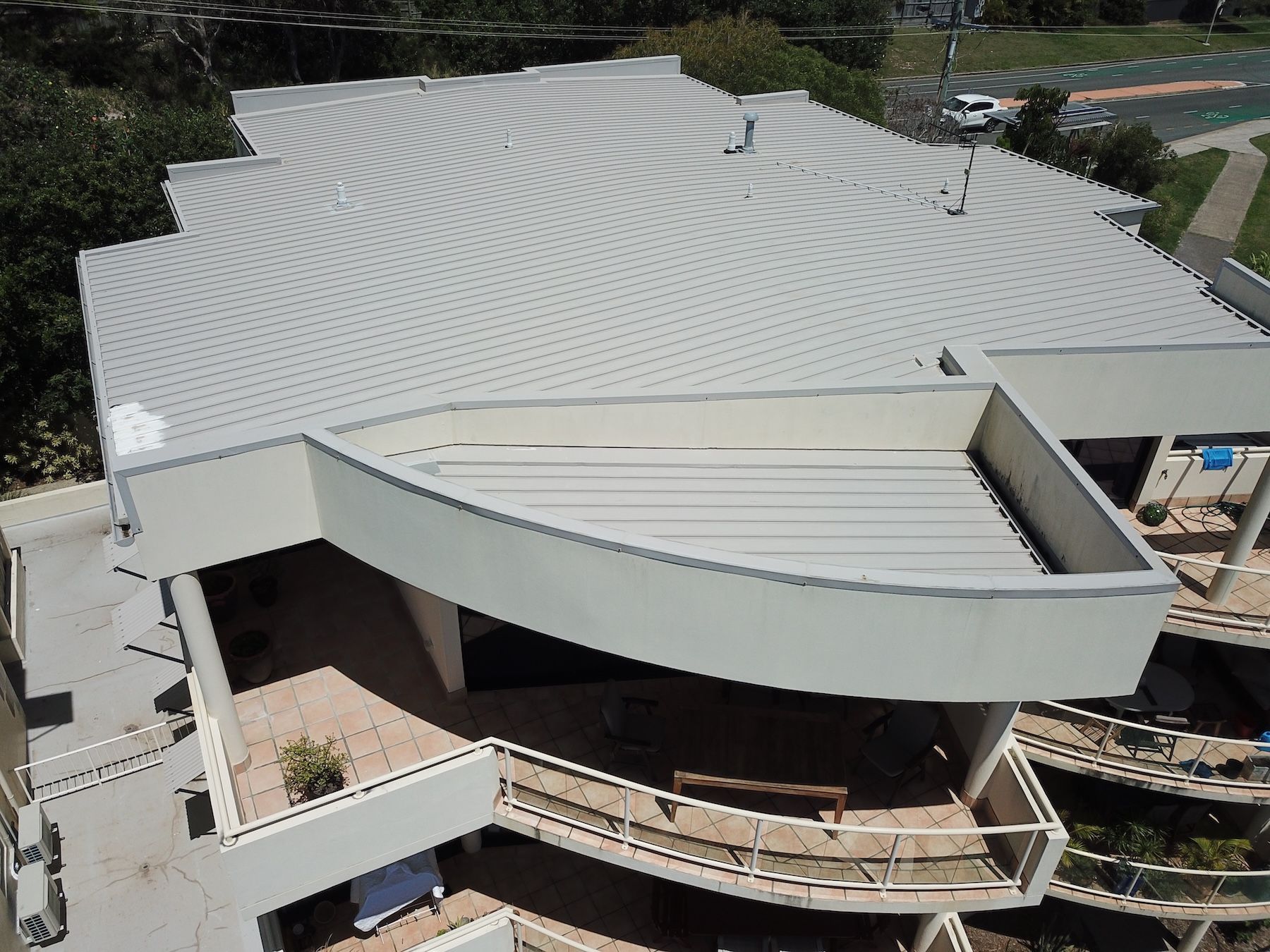 A White House With A Metal Roof And A White Gutter — Coastal Roof & Gutter Services In Coolum Beach, QLD