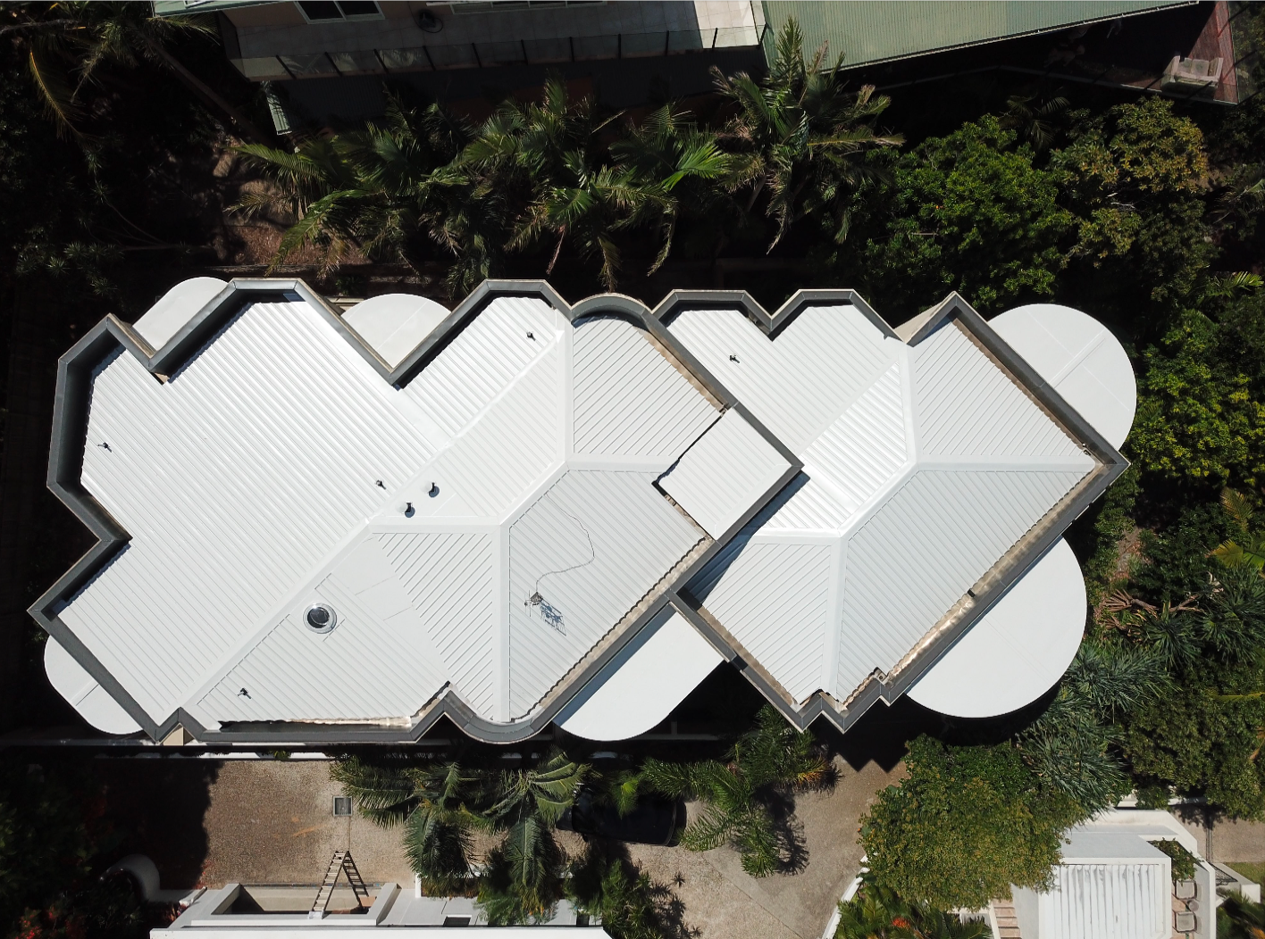 An Aerial View Of A House With A White Roof And A Pool — Coastal Roof & Gutter Services In Coolum Beach, QLD