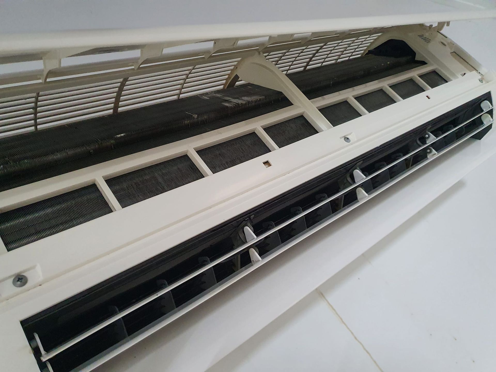 An Air Conditioning Unit with Visible Coils — Coach That Cleans in Speewah, QLD