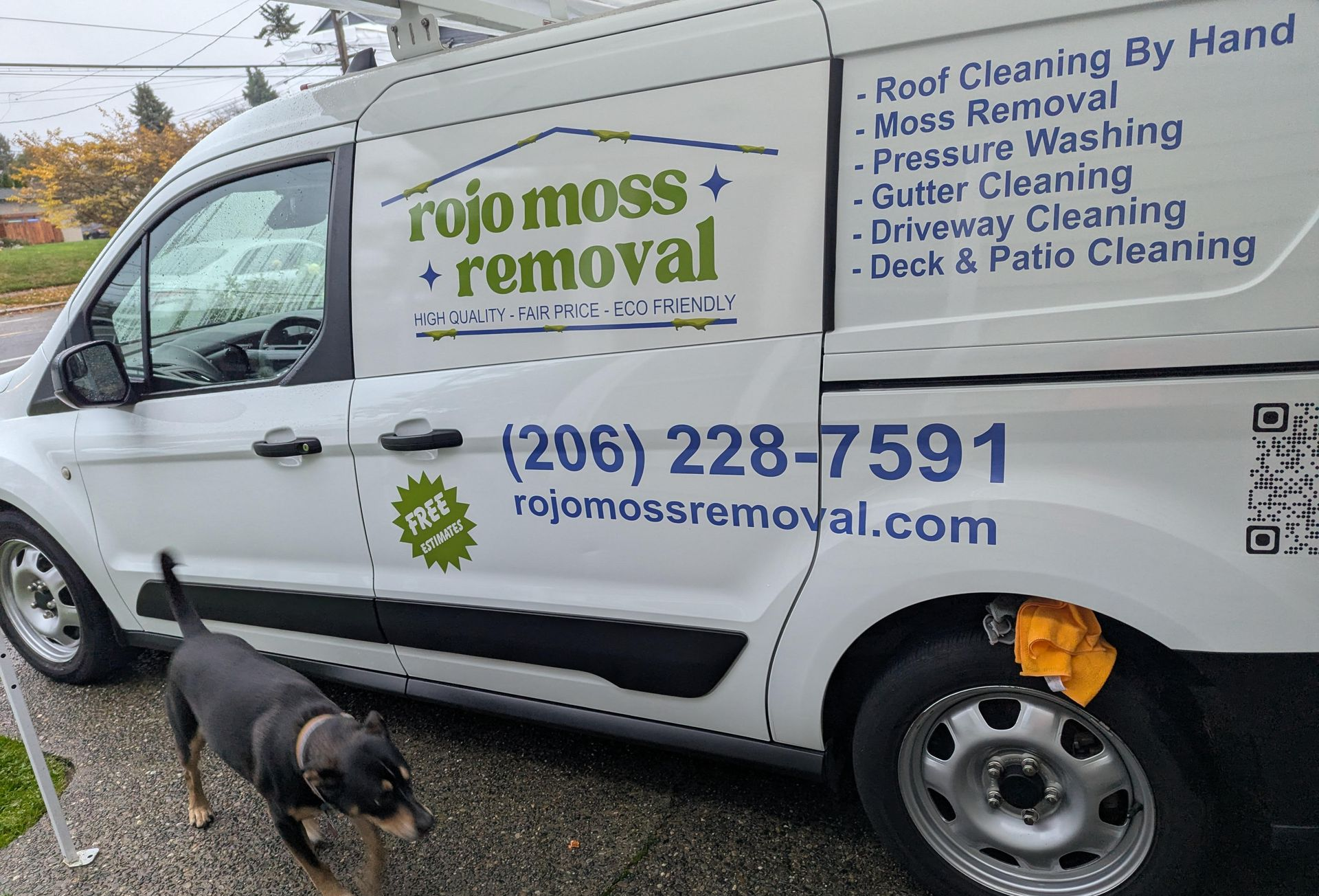 Rojo Moss Removal van with decals and a friendly dog