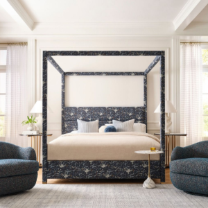 Elegant bedroom with dark walls, tufted ottoman, gray chair, mirror, and tall window with curtains
