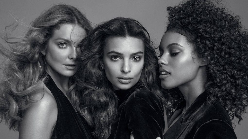 Three women are posing for a black and white photo.