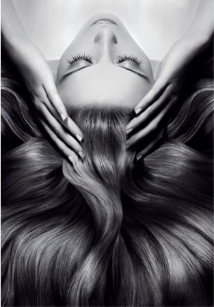 a woman is applying a conditioner to her hair .