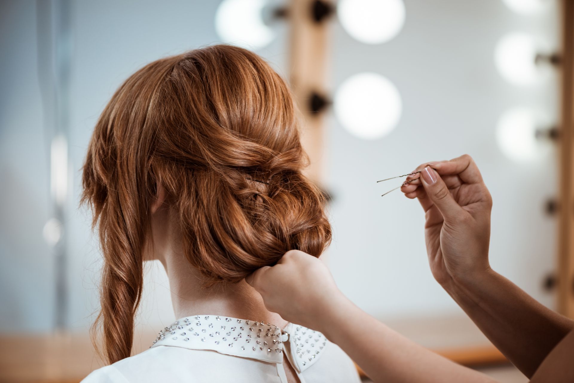a woman is getting her hair done by a hairdresser .