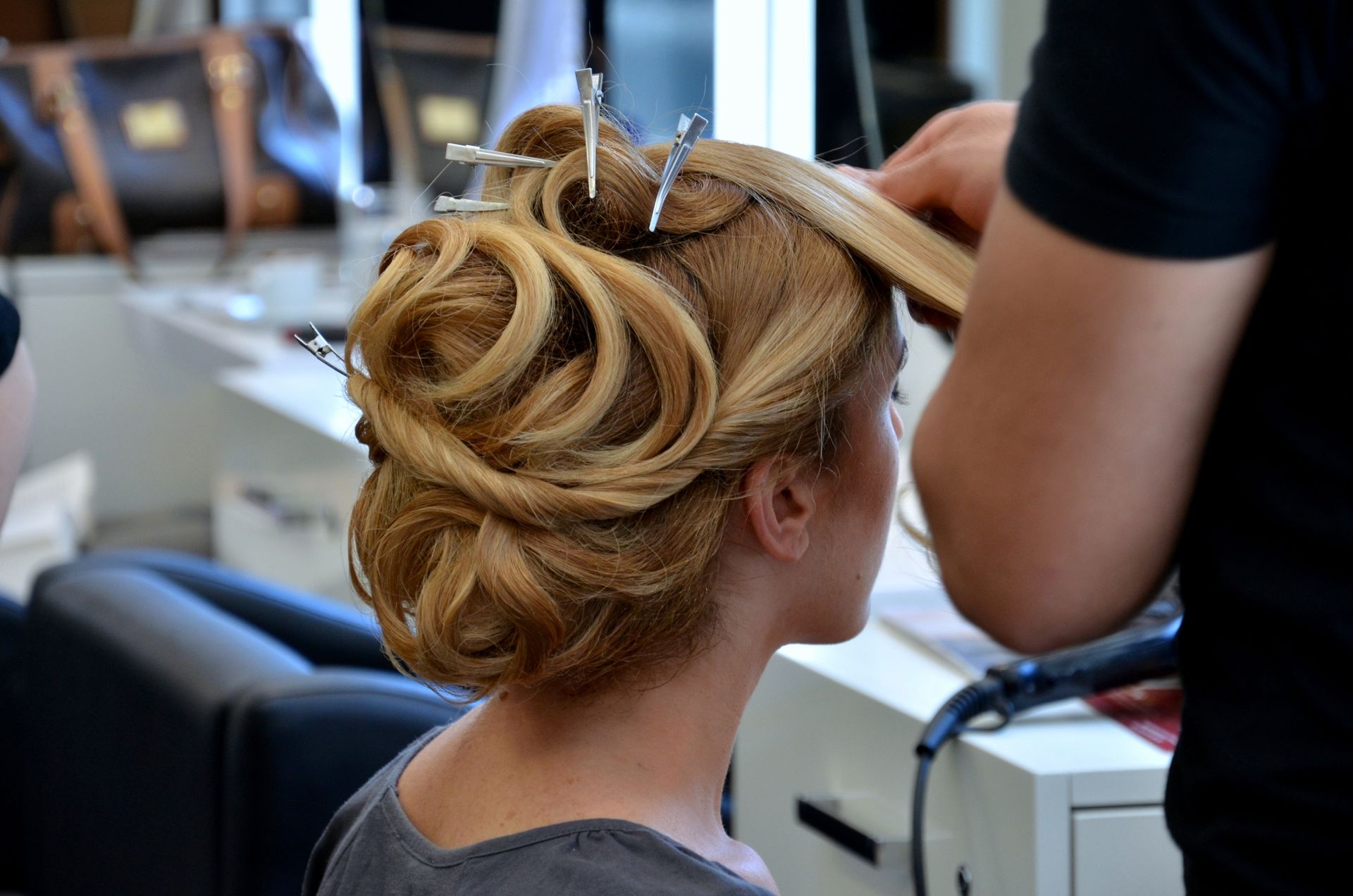a woman is getting her hair done by a hairdresser .