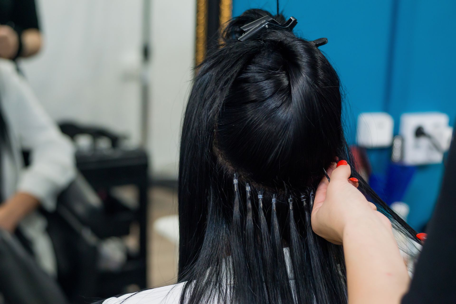 a woman is getting her hair dyed in a salon .