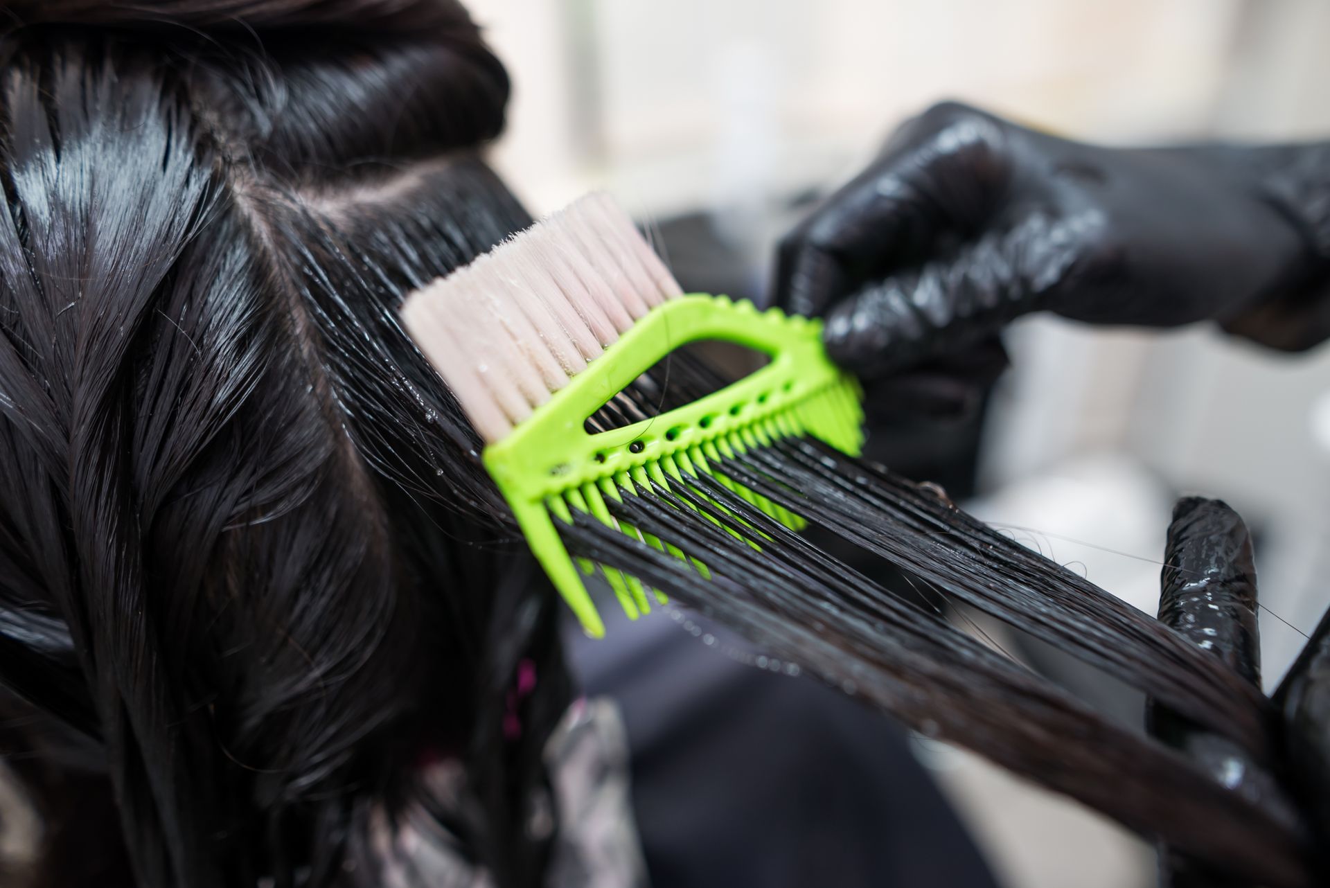 a woman is getting her hair permed by a hairdresser .