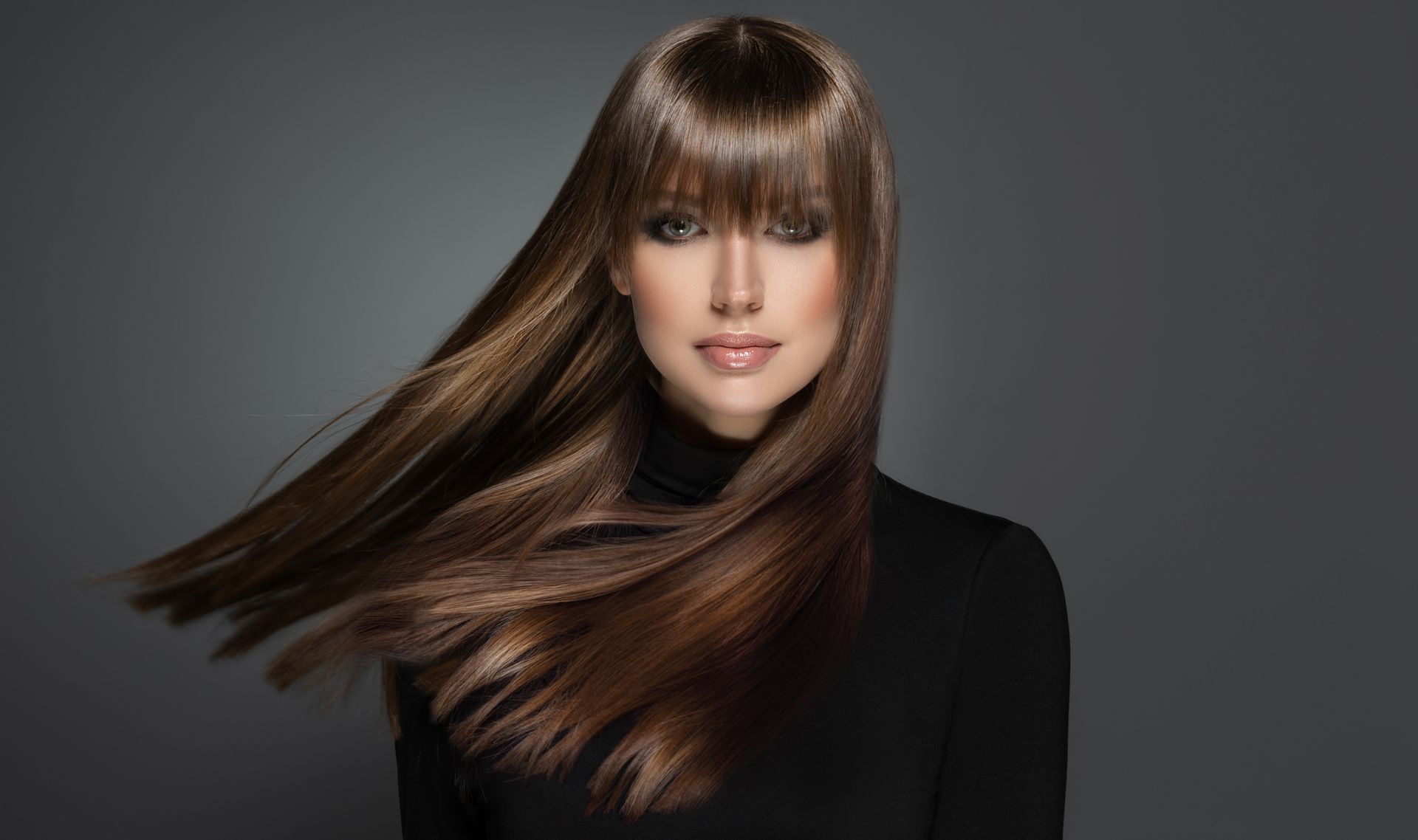 a woman in a black dress with glossy straight hair