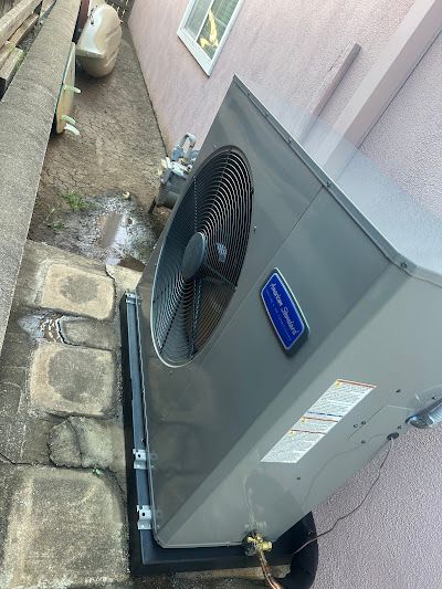 Tip of the Spear HVAC | a large air conditioner is sitting on the side of a building.