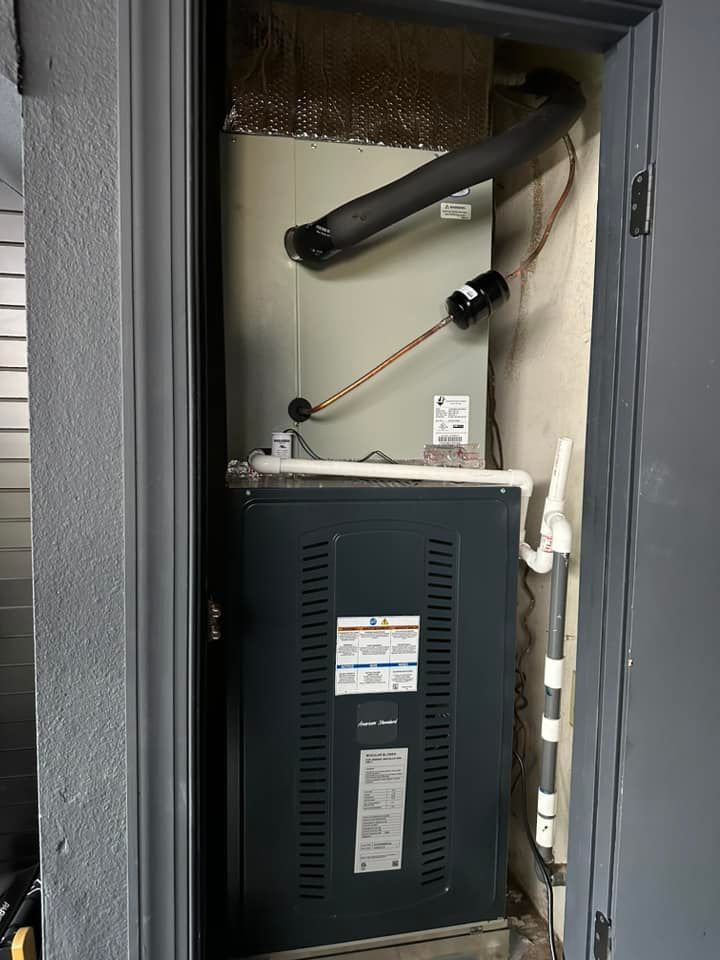 Tip of the Spear HVAC | an air conditioner is sitting in a closet next to a door.