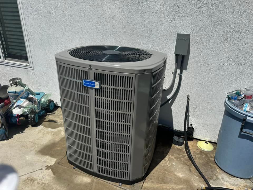 Tip of the Spear HVAC | a large air conditioner is sitting on the side of a building.