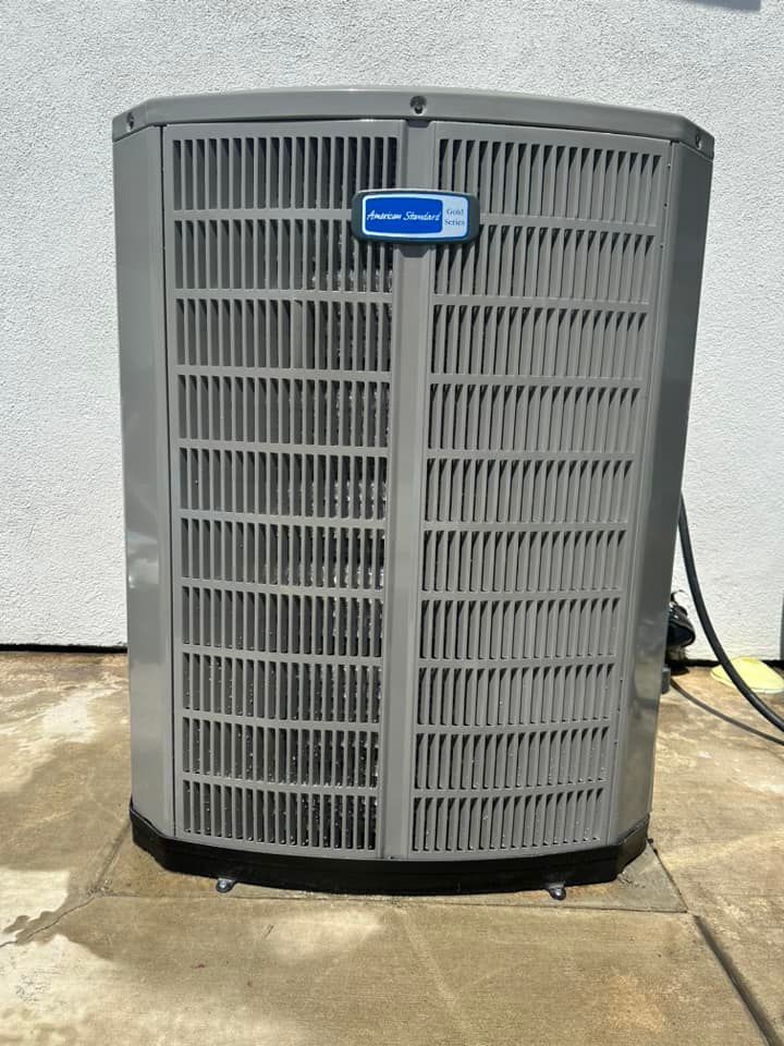 Tip of the Spear HVAC | a gray air conditioner is sitting on a concrete surface