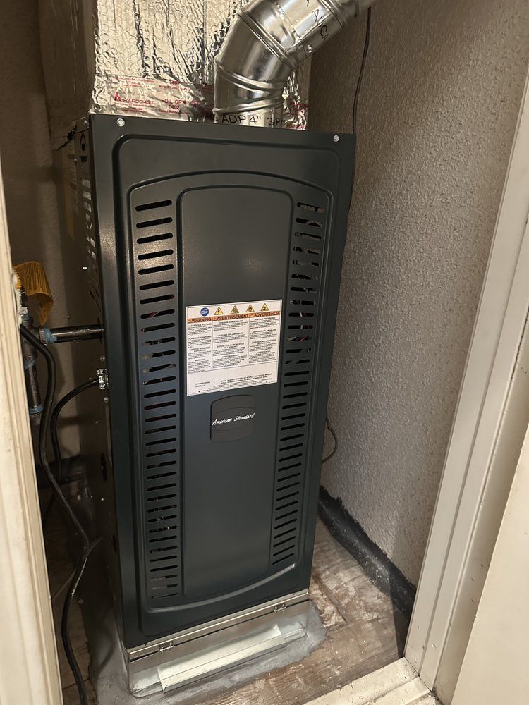 Tip of the Spear HVAC | an air conditioner is sitting in a closet next to a door.