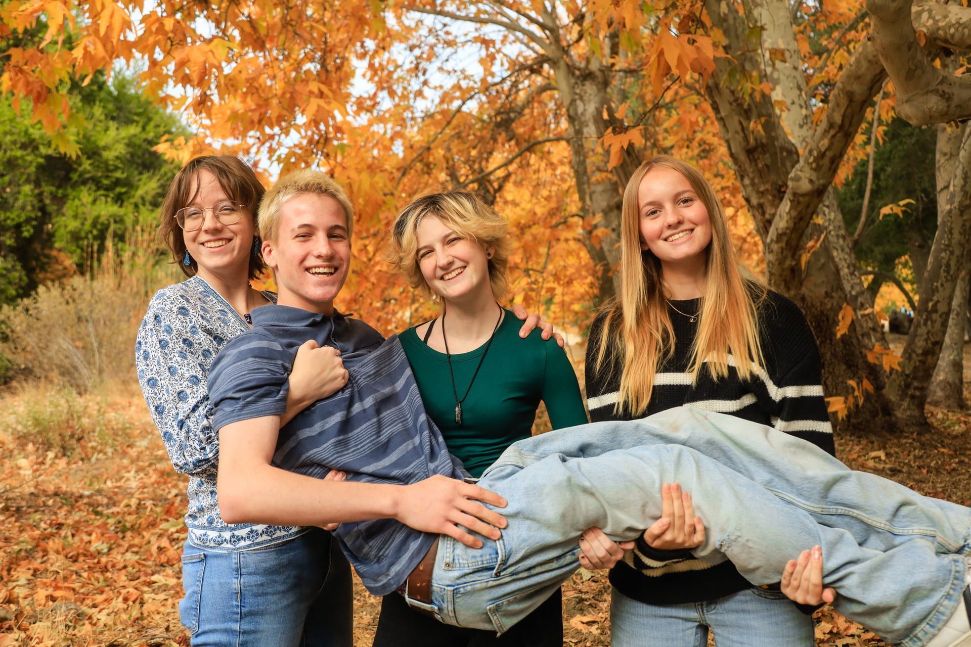family in fall leaves