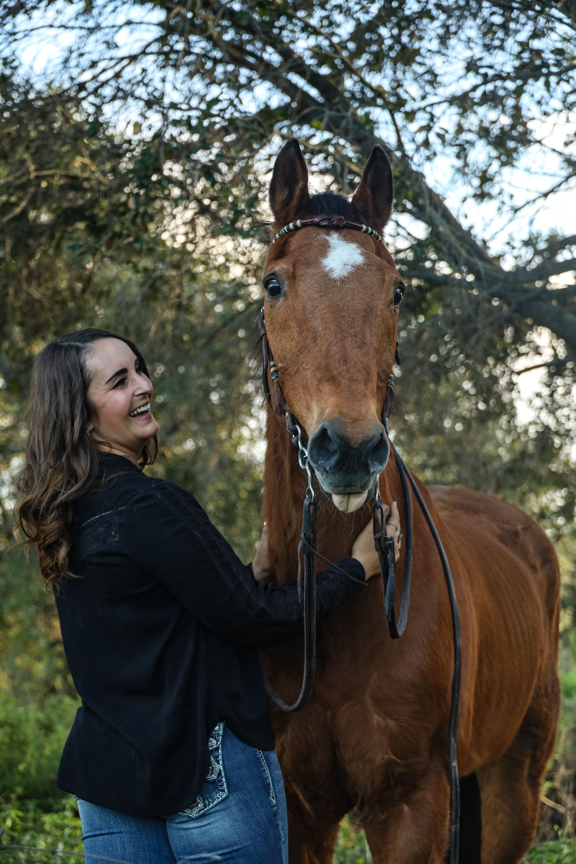 girl laughing at horse