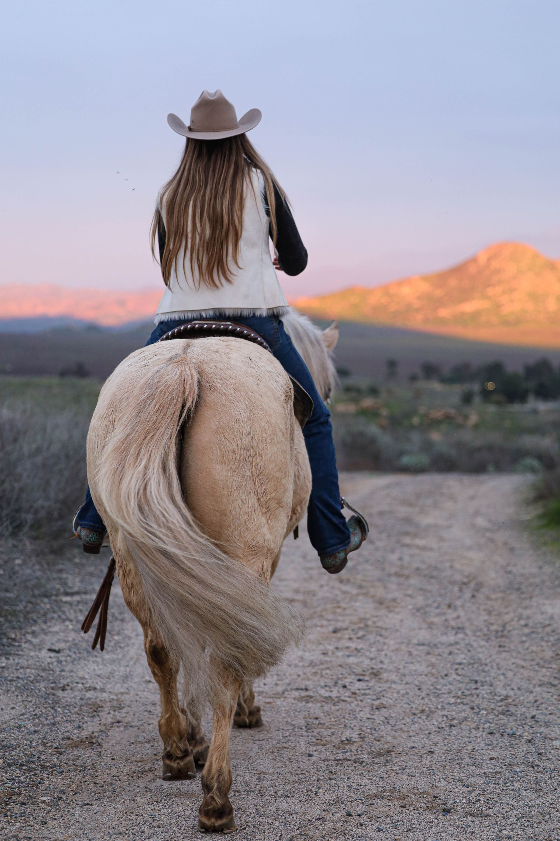 girl riding towards mountains