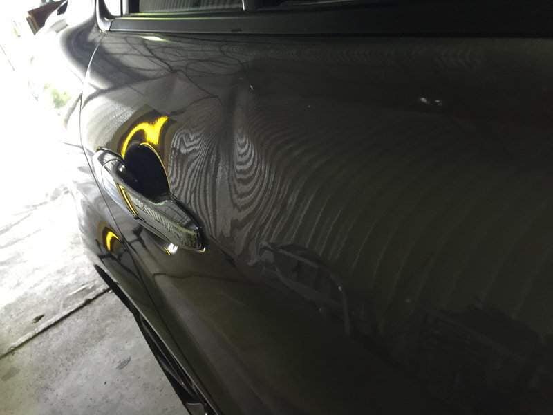 side view of a black car(before) — Dent Magic in Coffs Harbour, NSW