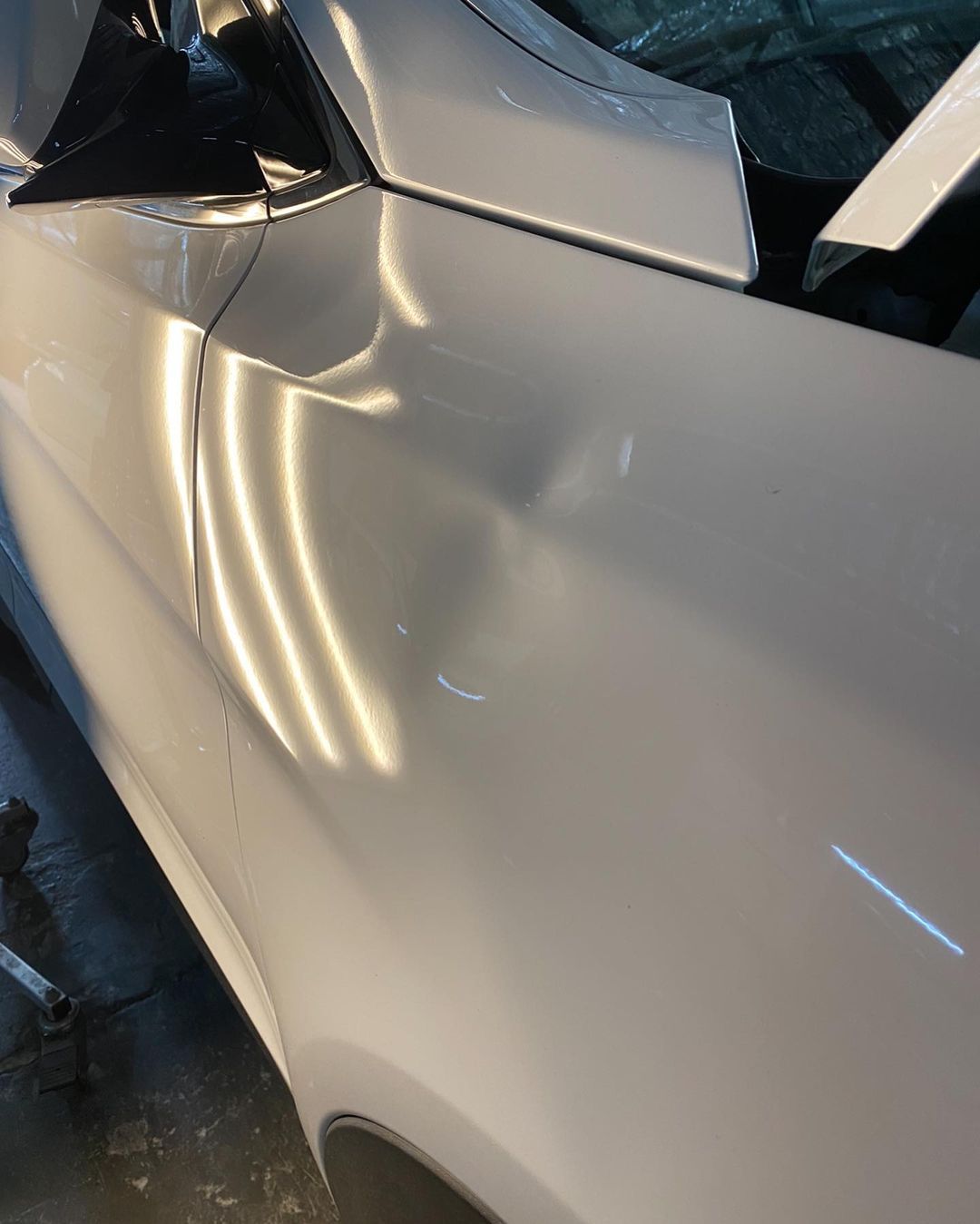 Front Guard White Car Before Dent Removal — Dent Magic in Coffs Harbour, NSW