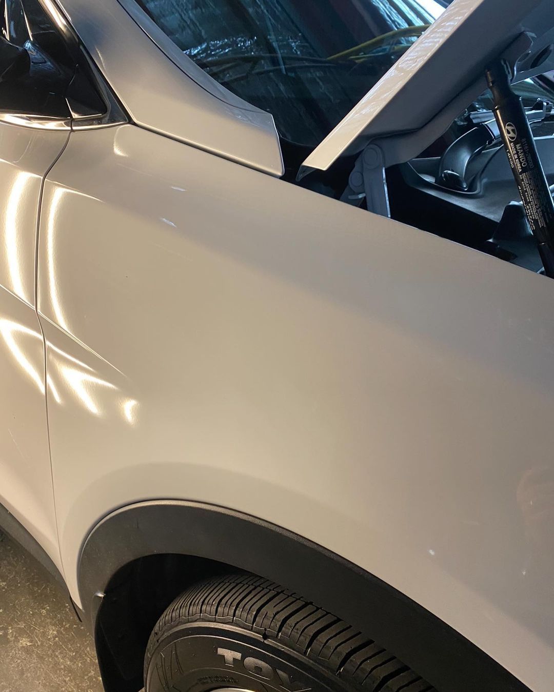 Front Guard White Car After Dent Removal — Dent Magic in Coffs Harbour, NSW