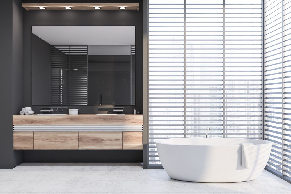 A Bathroom With a Tub, Sink, Mirror and Blinds — Barling Constructions in Casino, NSW