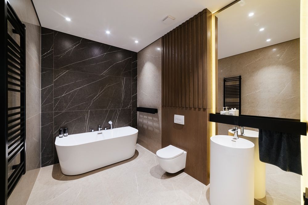 A Bathroom With a Bathtub, Toilet, Sink and Mirror — Barling Constructions in Casino, NSW