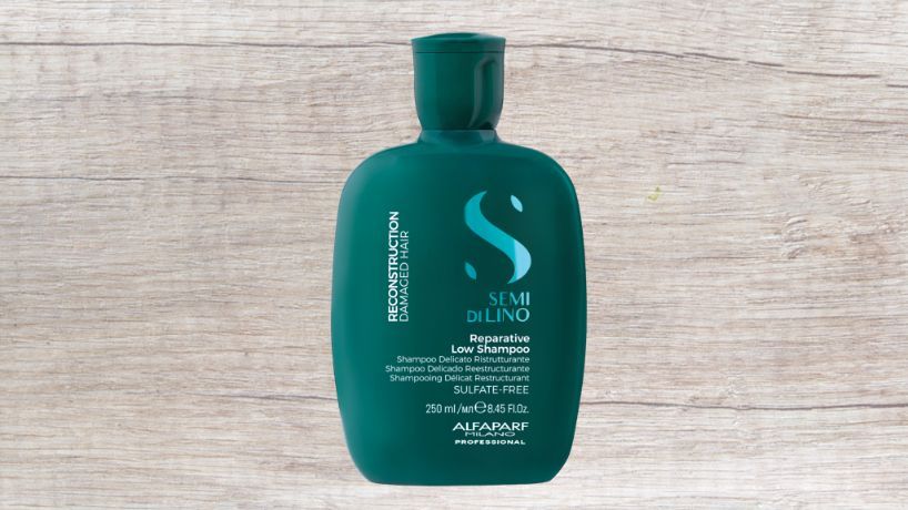 A Bottle of Reparative Mask is Sitting on a Wooden Table — Superb Hair in Wyong, NSW