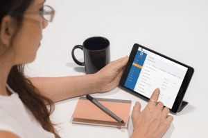 Businesswoman using a tablet iPad with RatesCalc on the screen