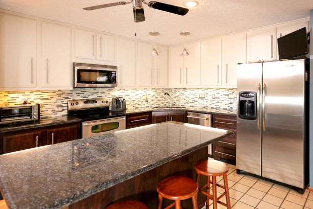 White Upper Cabinets With Dark Brown Lower Cabinets Kitchen Remodel by Tailored Roofing and Remodeling Inc. project photo 2