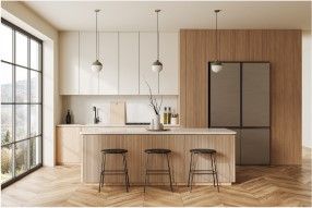 Modern kitchen with wooden and white cabinetry, island with stools, large windows, and pendant lights.