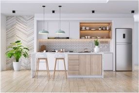 Modern kitchen with white cabinetry, light wood island, and stainless steel refrigerator.