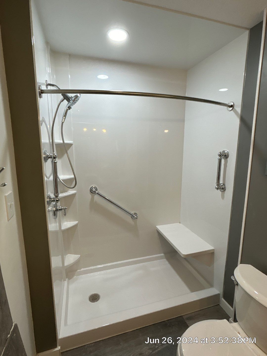 Accessible walk-in shower with grab bars and built-in seat