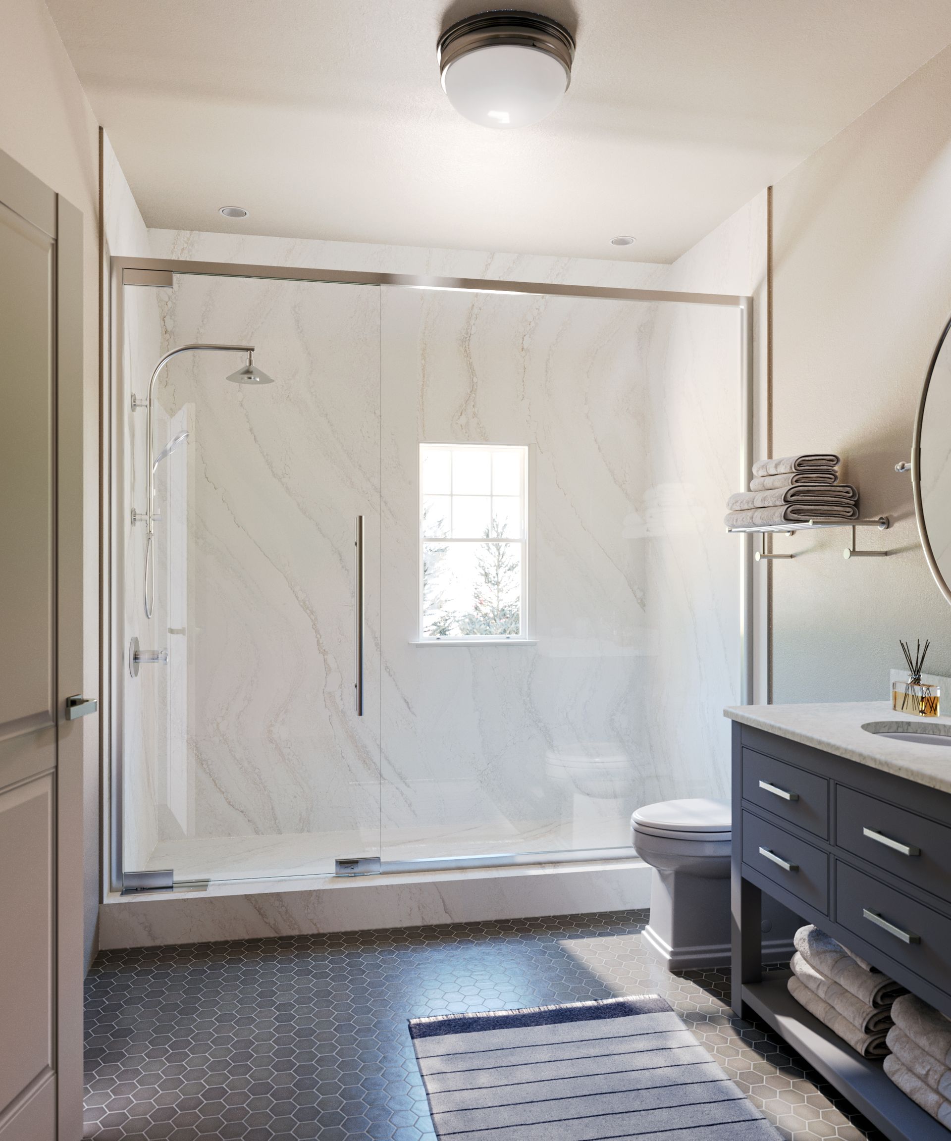 A modern bathroom with a glass-enclosed shower, a dark blue vanity, and a gray-tiled floor.