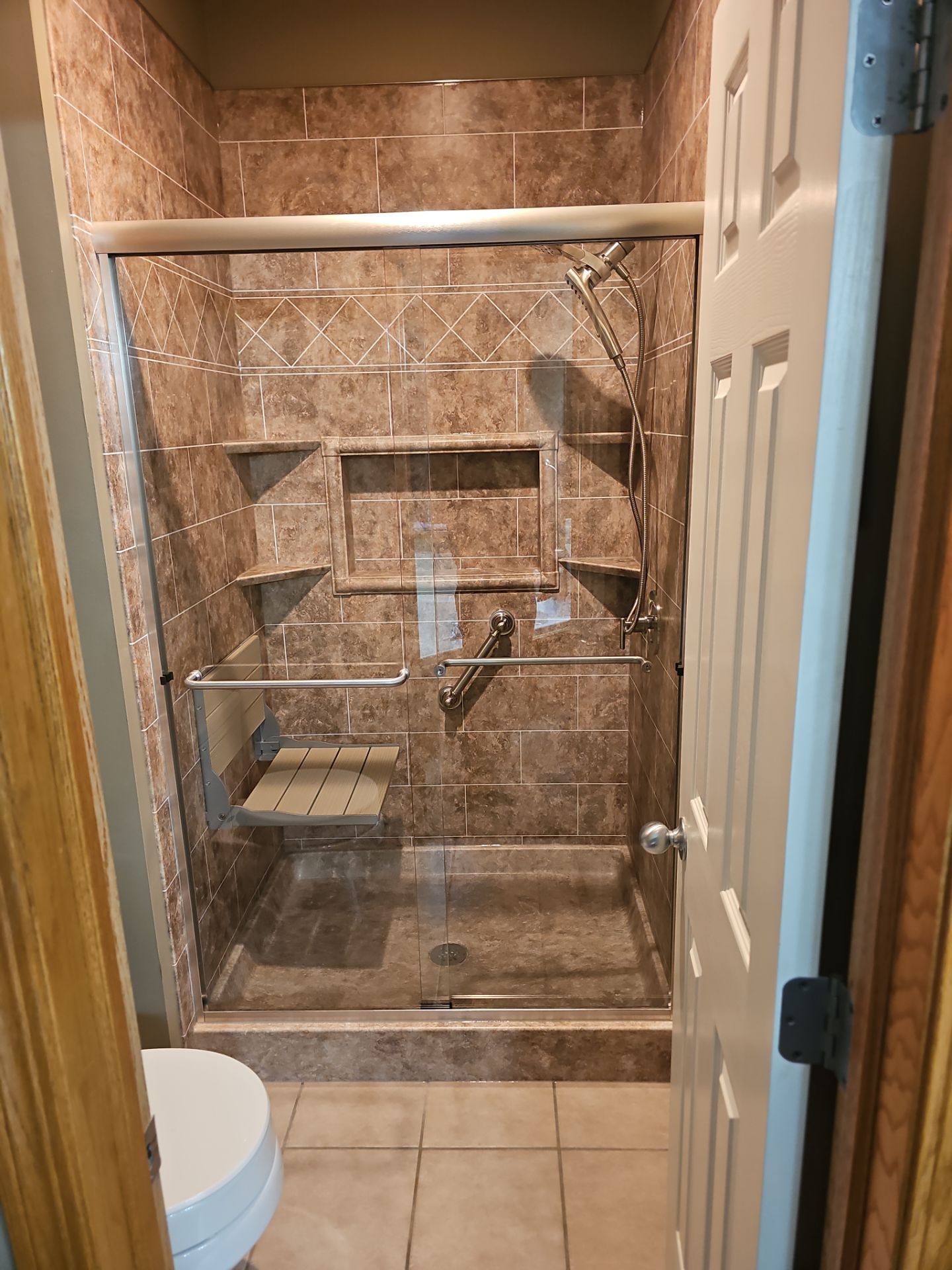 Bathroom shower with brown tiles