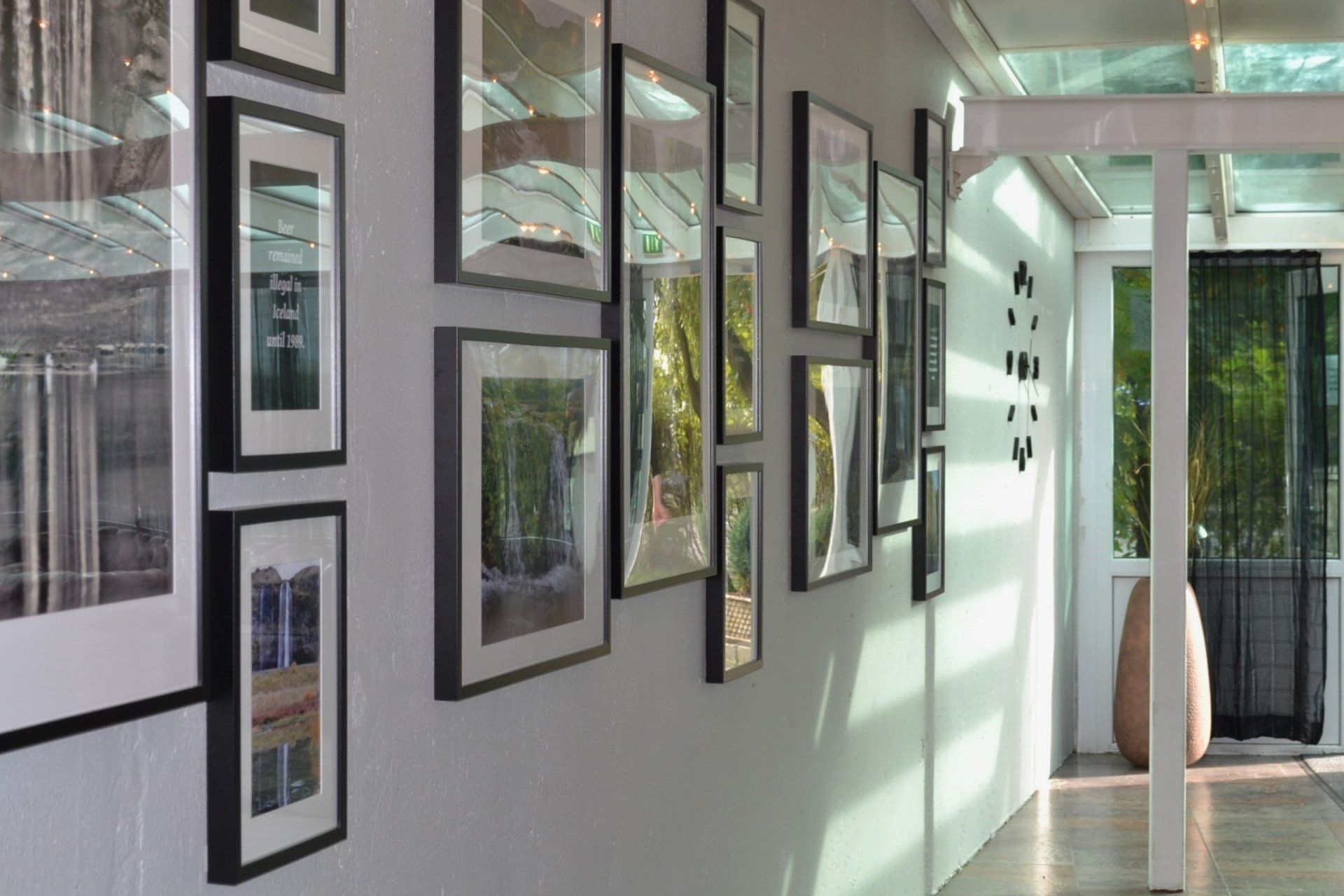 A hallway with a lot of framed pictures on the wall