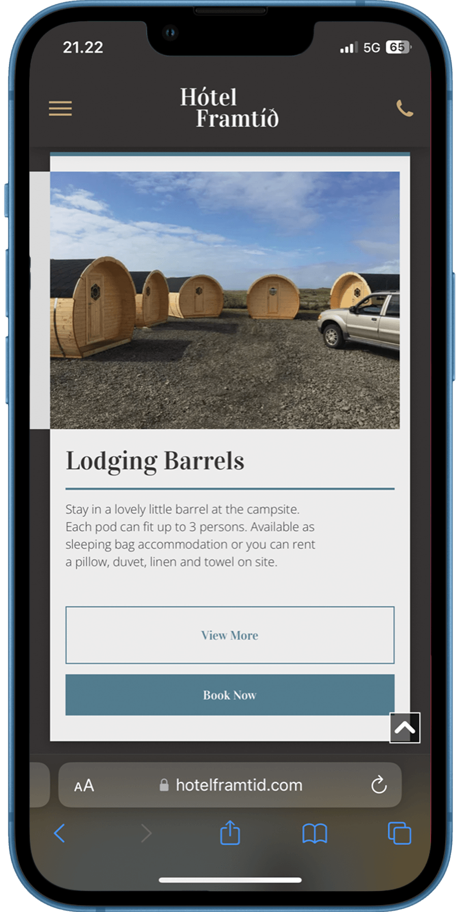 A cell phone with a picture of lodging barrels on the screen.