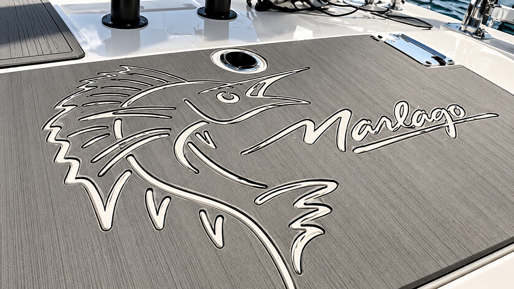 Metal dolphin logo on a gray textured surface with the word “Marlie” in script.