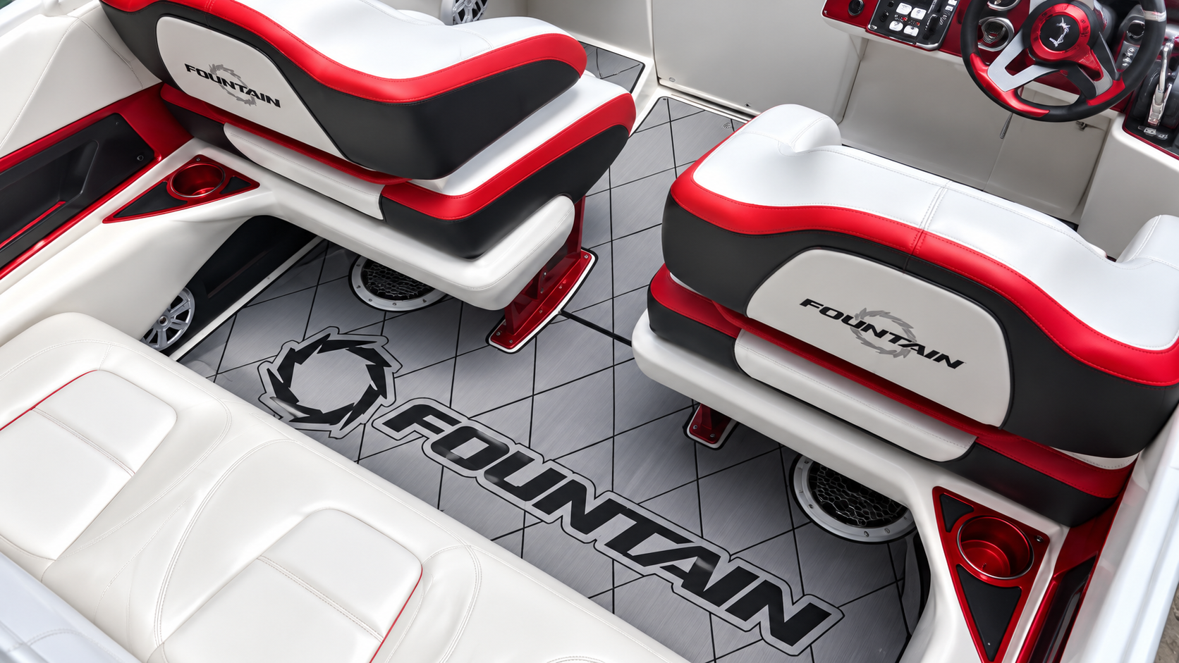 Red and white gaming room with curved couches, black floor mat, and OMAN logo on the floor